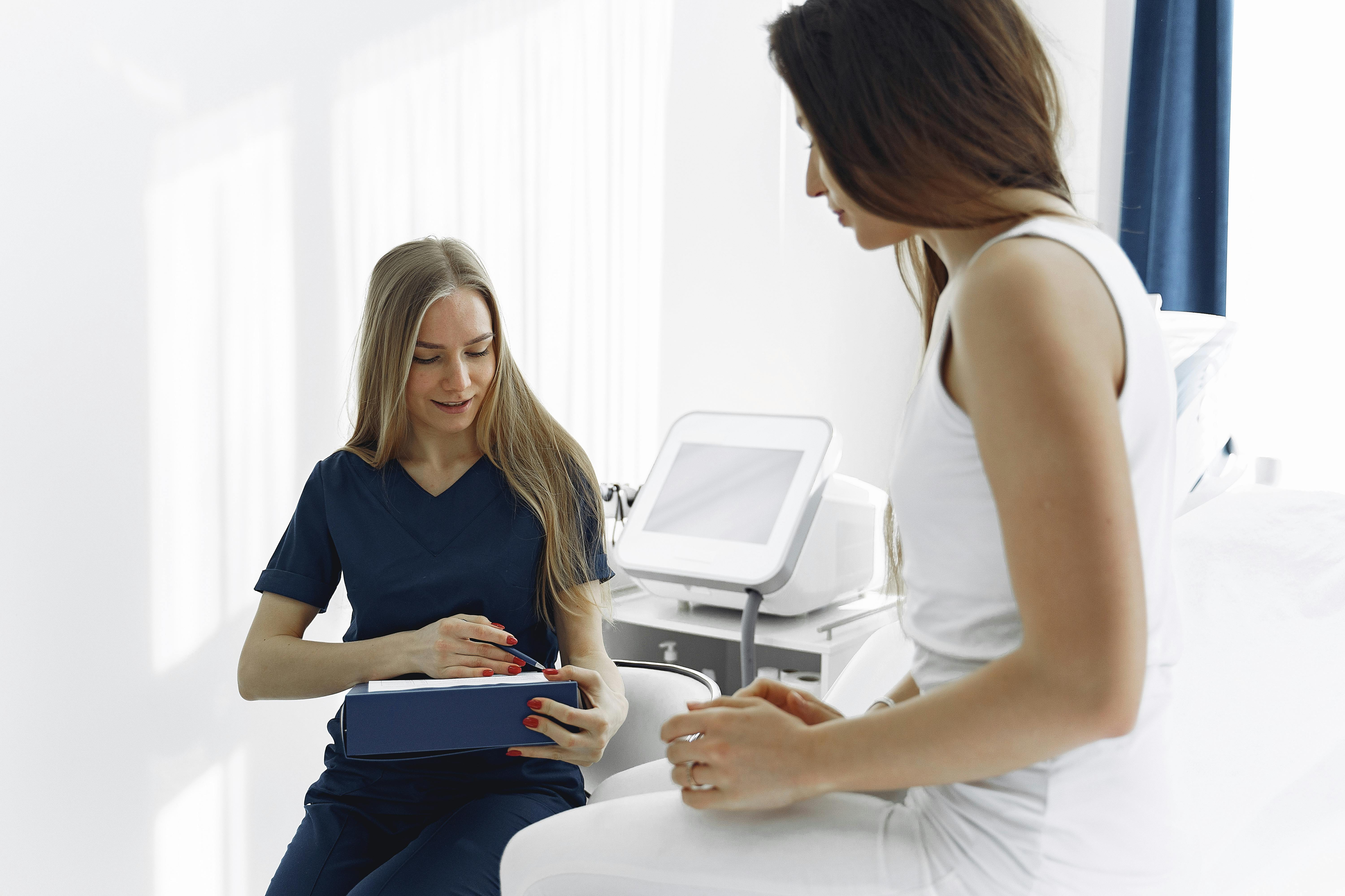 nurse practitioner talking with female patient