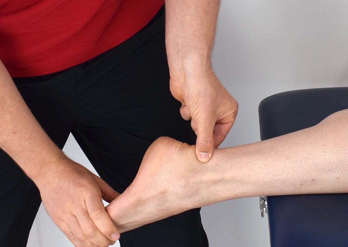 person getting their clicking Achilles tendon examined