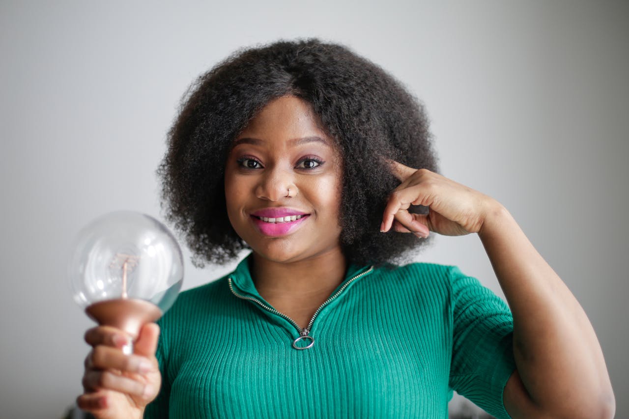 woman holding lightbulb because she has an idea