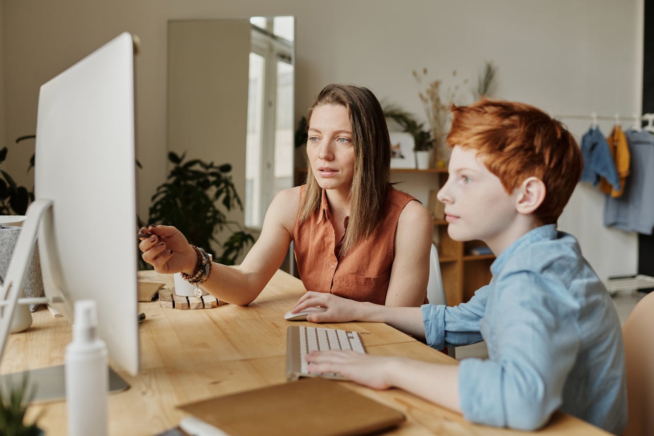 child with adhd working one on one with teacher at computer