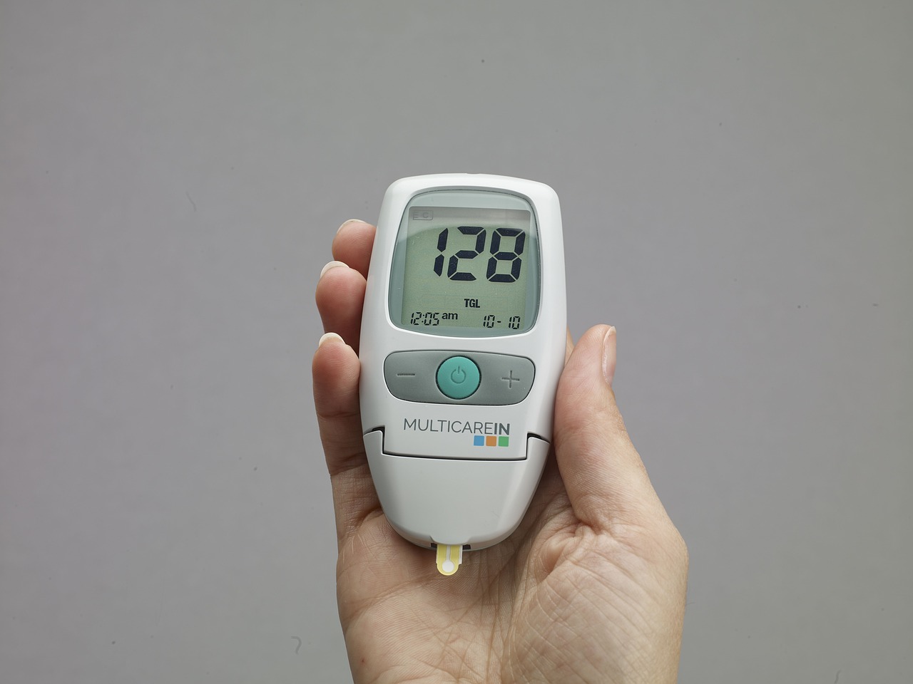 person holding glucometer