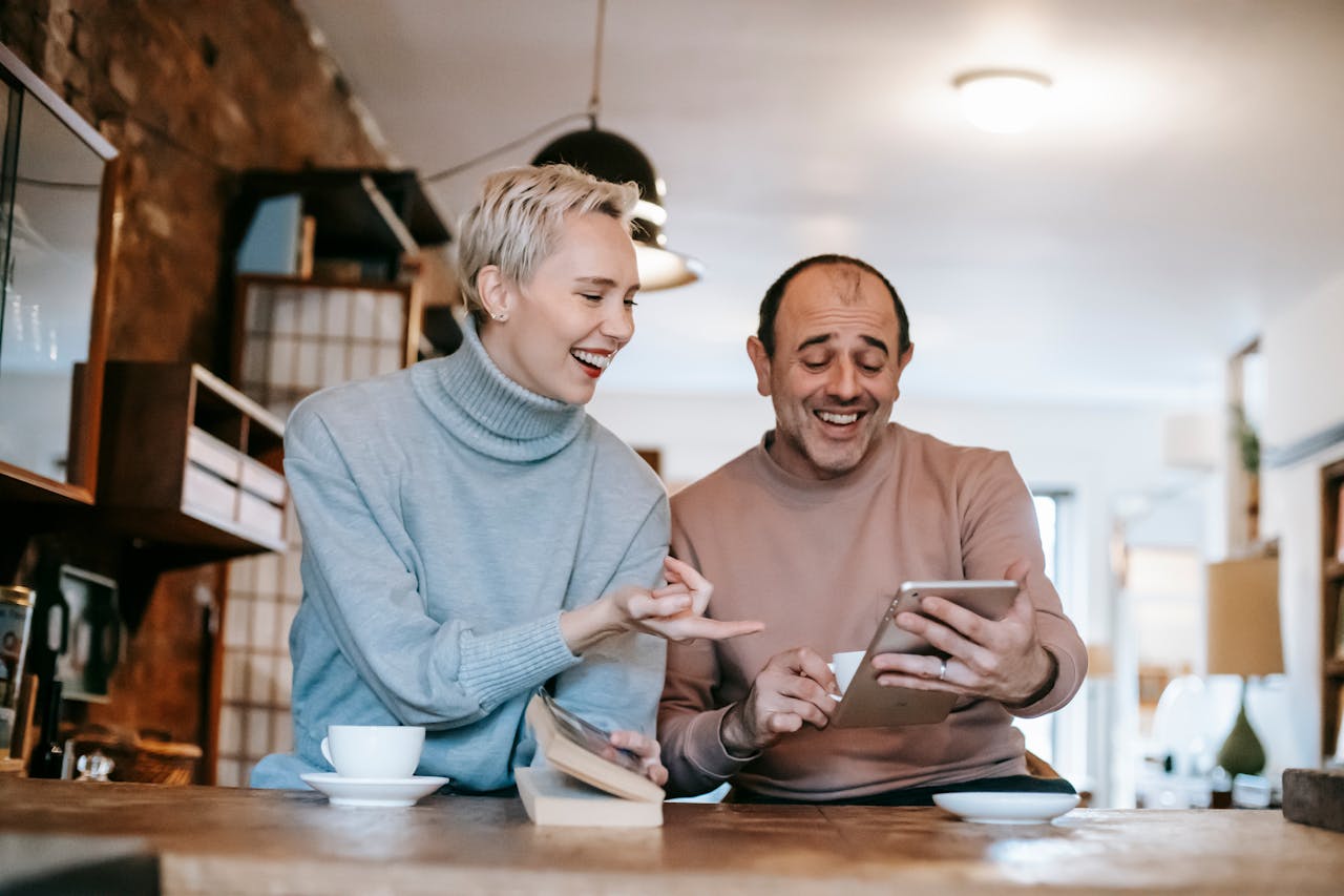 man and woman looking at tablet