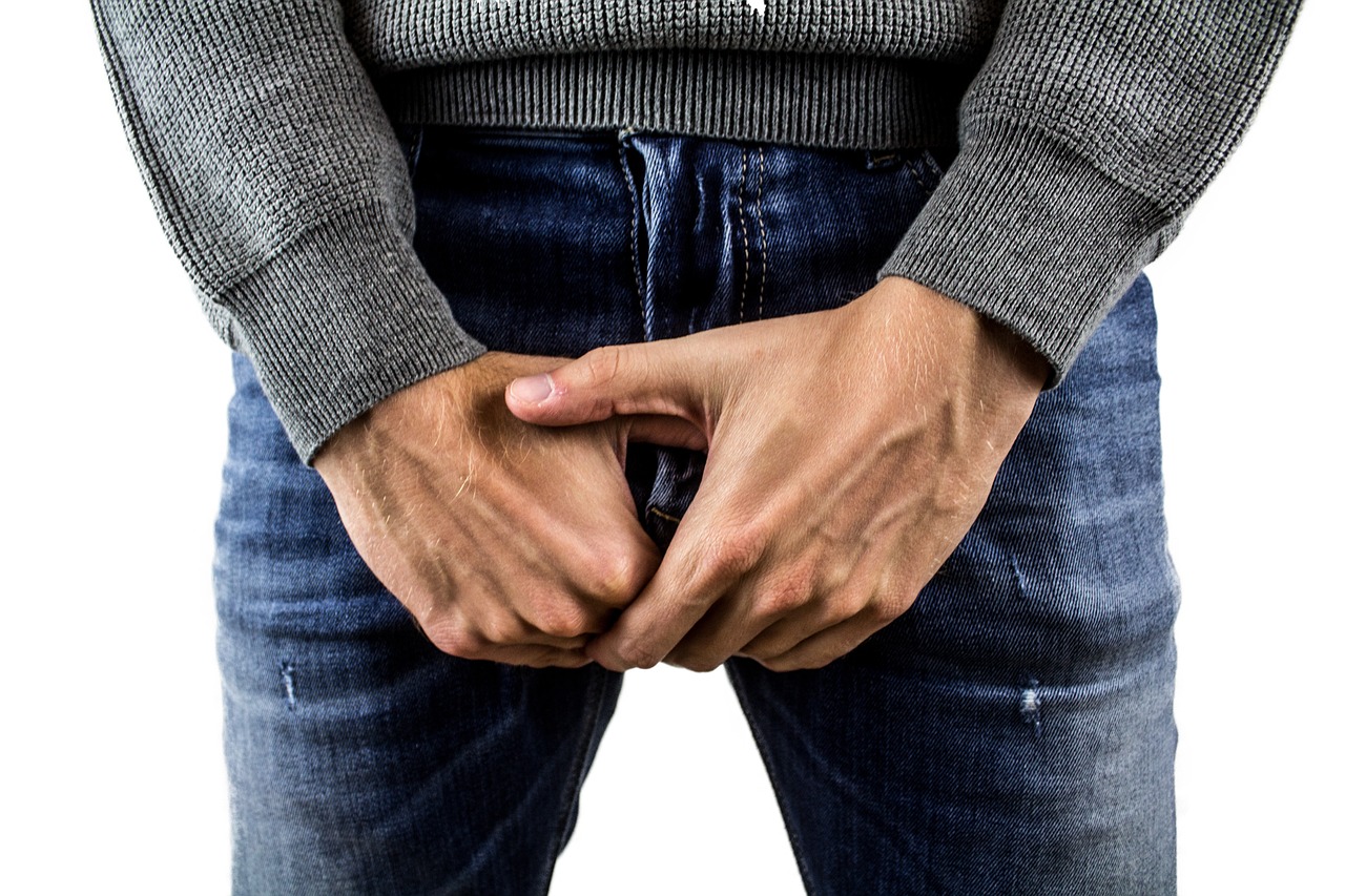 clothed man holding his grain area