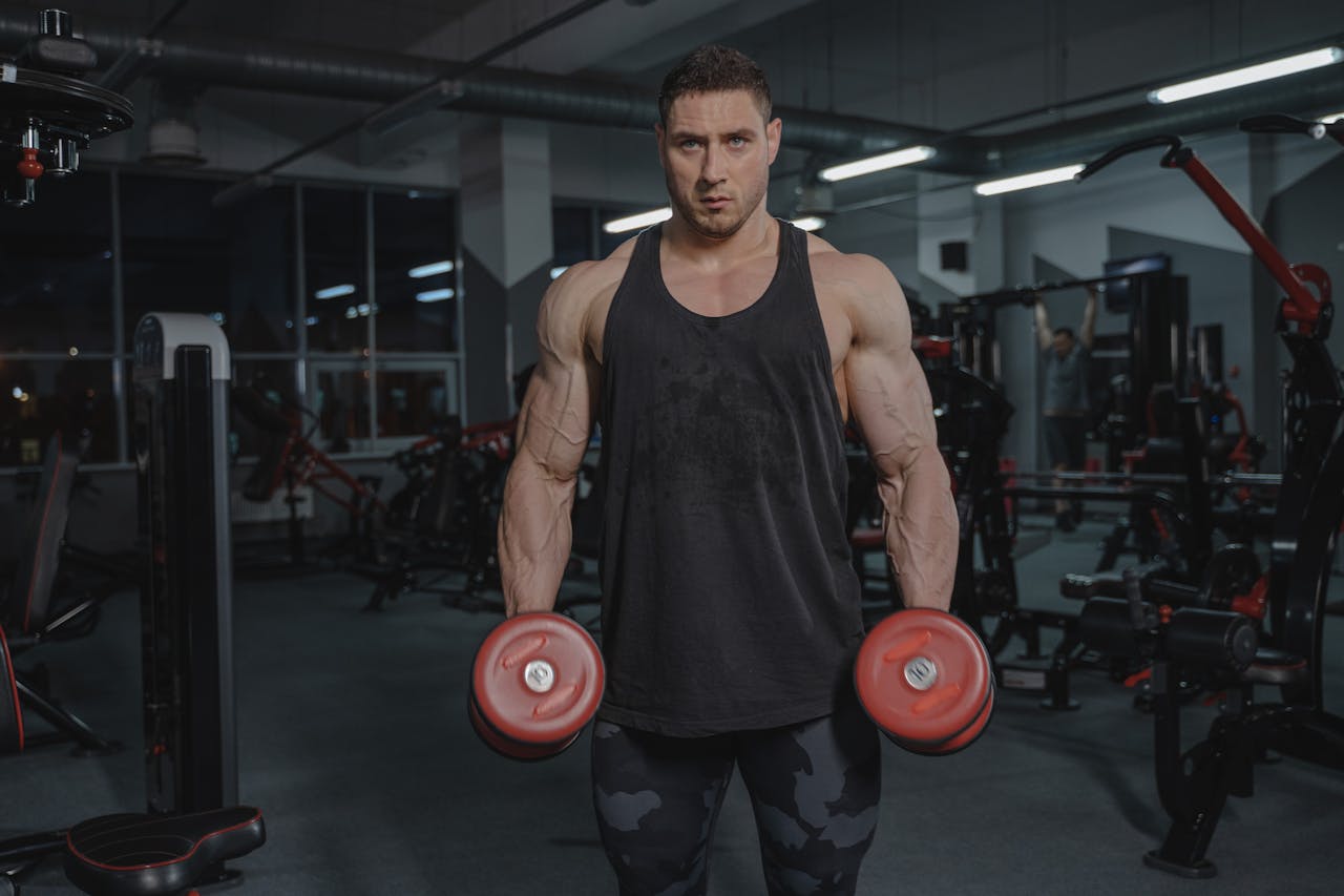 man with dumbbells who likely takes creatine as part of his workout program