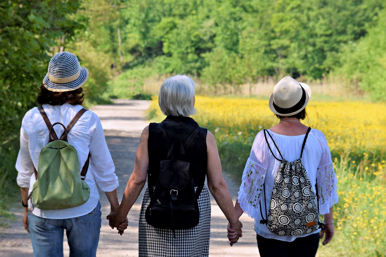 Three menopausal women walking and holding hands