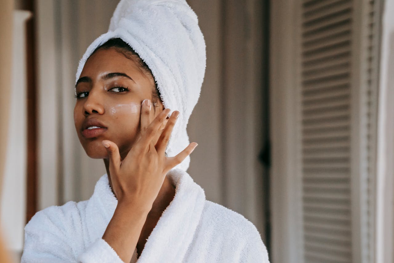 woman applying a collagen face mask cream