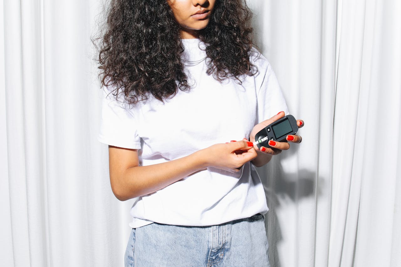 woman checking her blood sugar while standing