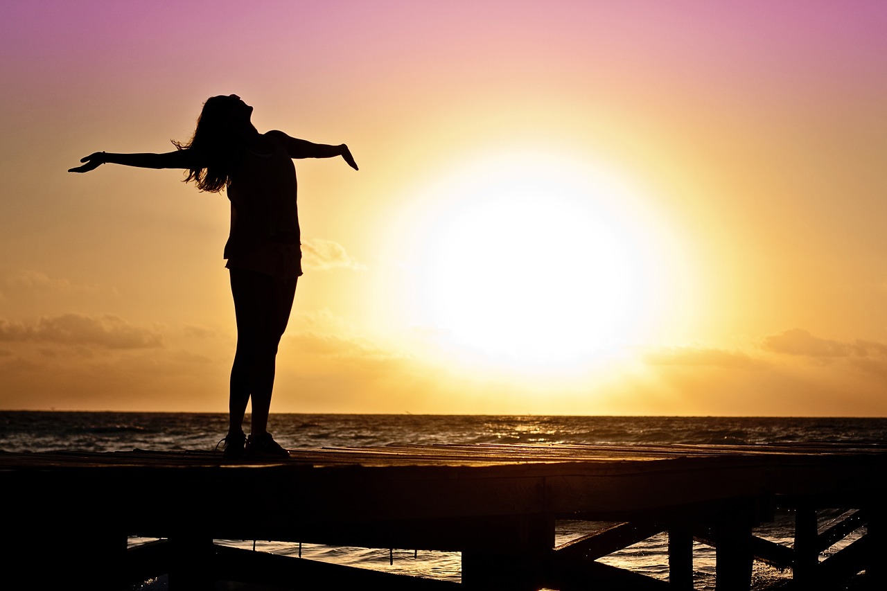 woman excited looking at sunrise