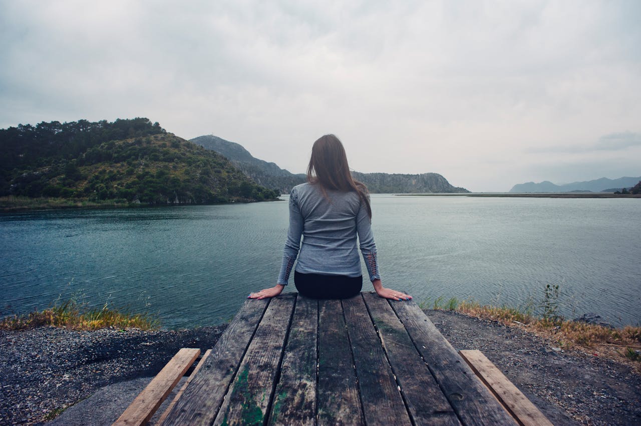 woman sitting on dock, happy mood