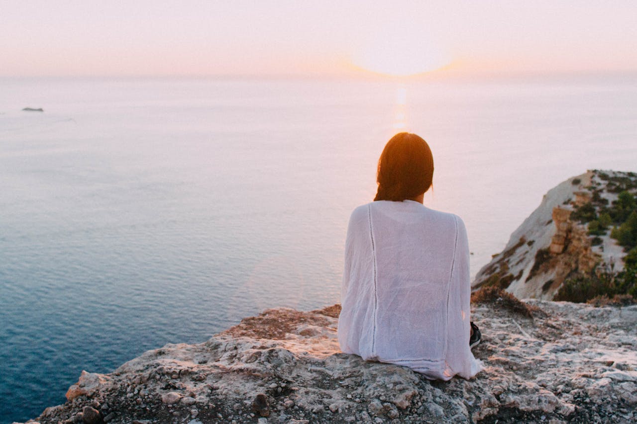 woman staring at ocean happily