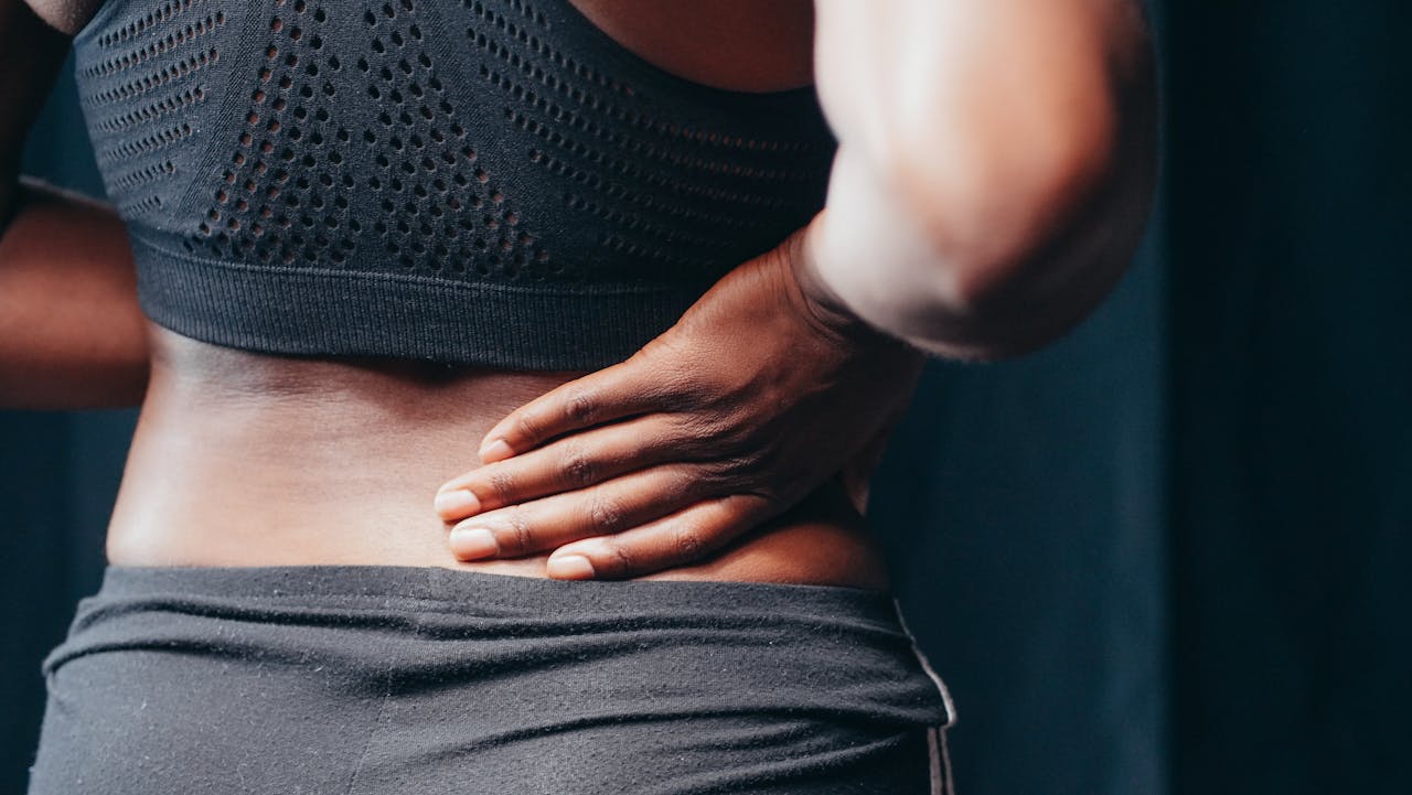 woman holding back due to pain