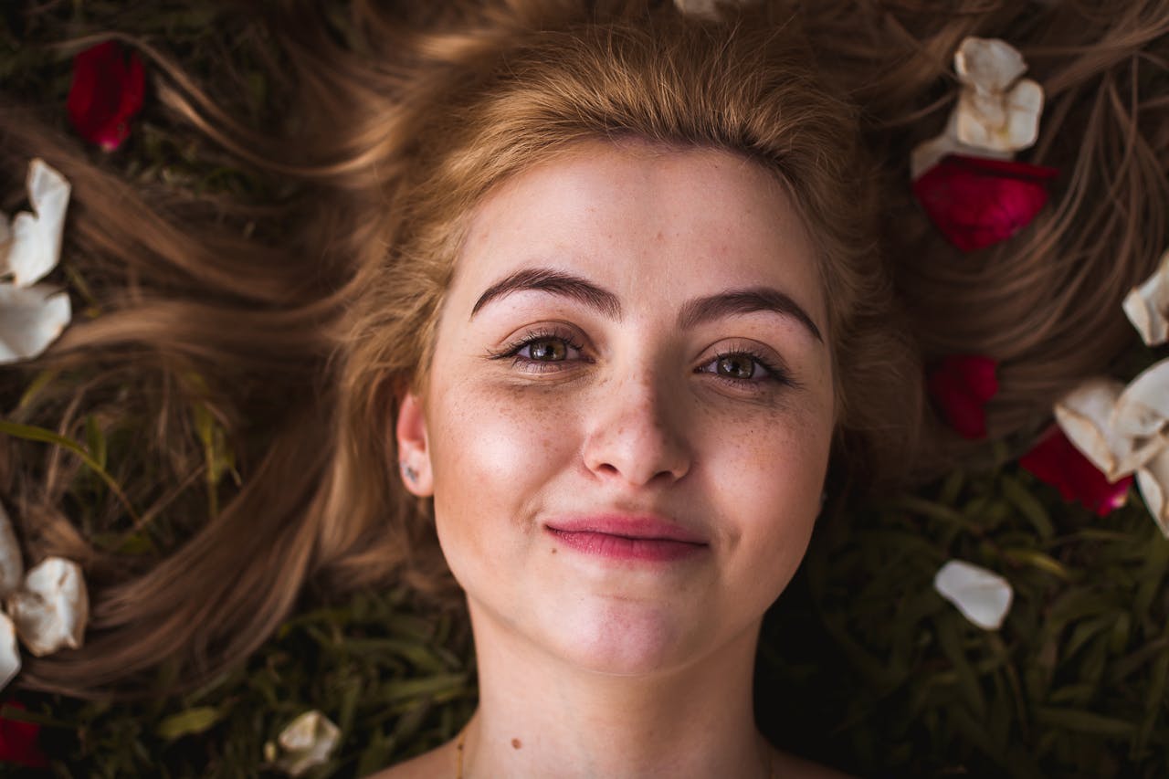 woman with nice healthy skin staring into camera and smiling